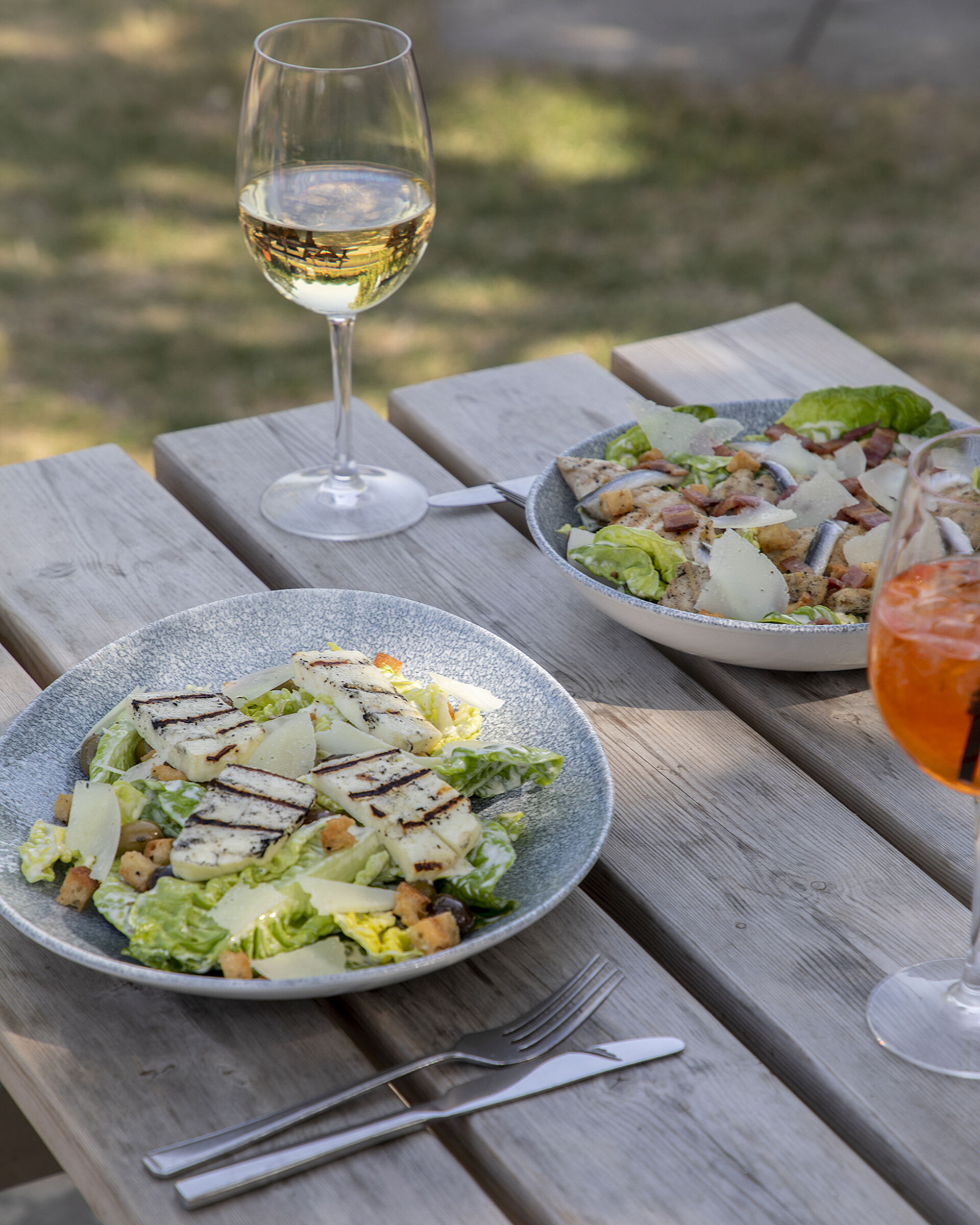 Halloumi Caesar salad with a glass of wine